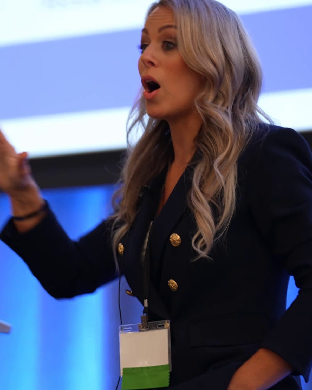 Marni Blythe mid-keynote, speaking with energy on stage
